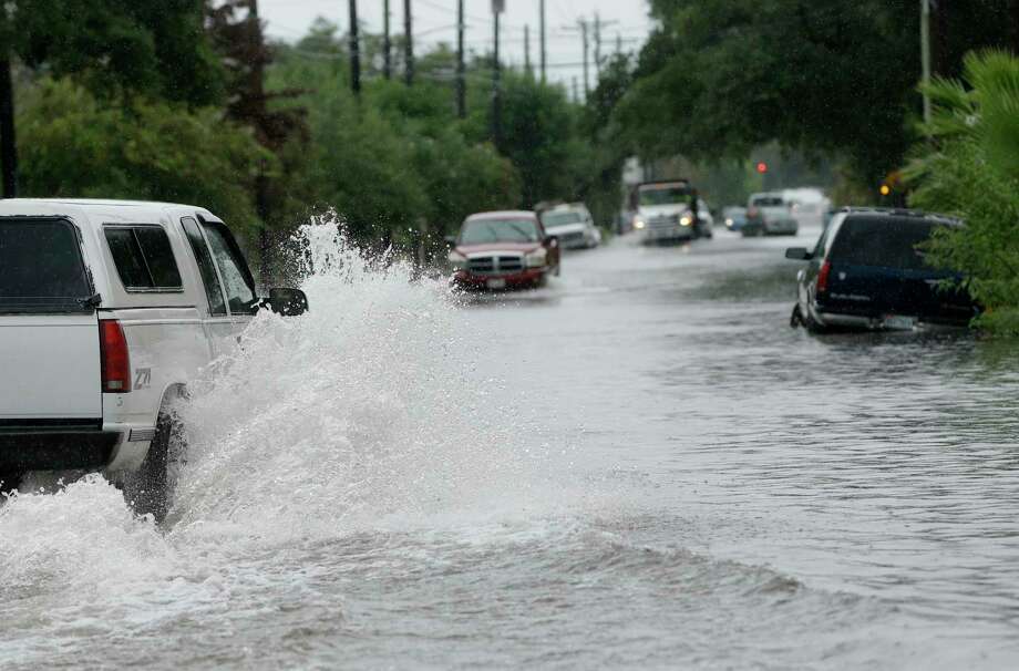 Vehicles drive through the flood roadway along 35th St. at Broadway Ave. Monday, Sept. 3, 2018, in Galveston. Photo: Melissa Phillip, Staff Photographer / © 2018 Houston Chronicle
