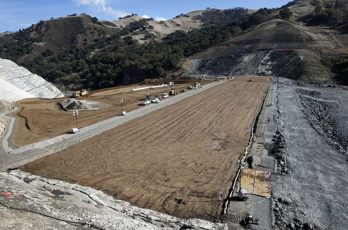 The core of the Calaveras Dam replacement project takes shape (center) with the rock-based reservoir side of the new dam seen (right) near Sunol, Calif. on Tuesday, Nov. 14, 2017. Construction crews have raised about half of the height of the new dam. The SFPUC is replacing the original seismically unreliable dam, which was completed in 1925, with a 220-foot high rock and earthen dam.