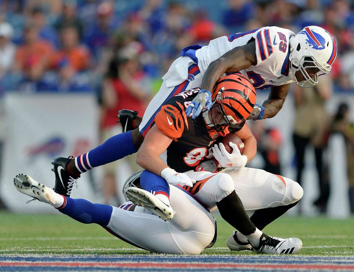 Cincinnati Bengals tight end Mason Schreck (86) is tackled by Buffalo Bills safety Siran Neal (29) and cornerback Breon Borders during the second half of a preseason NFL football game Sunday, Aug. 26, 2018, in Orchard Park, N.Y. (AP Photo/Adrian Kraus)