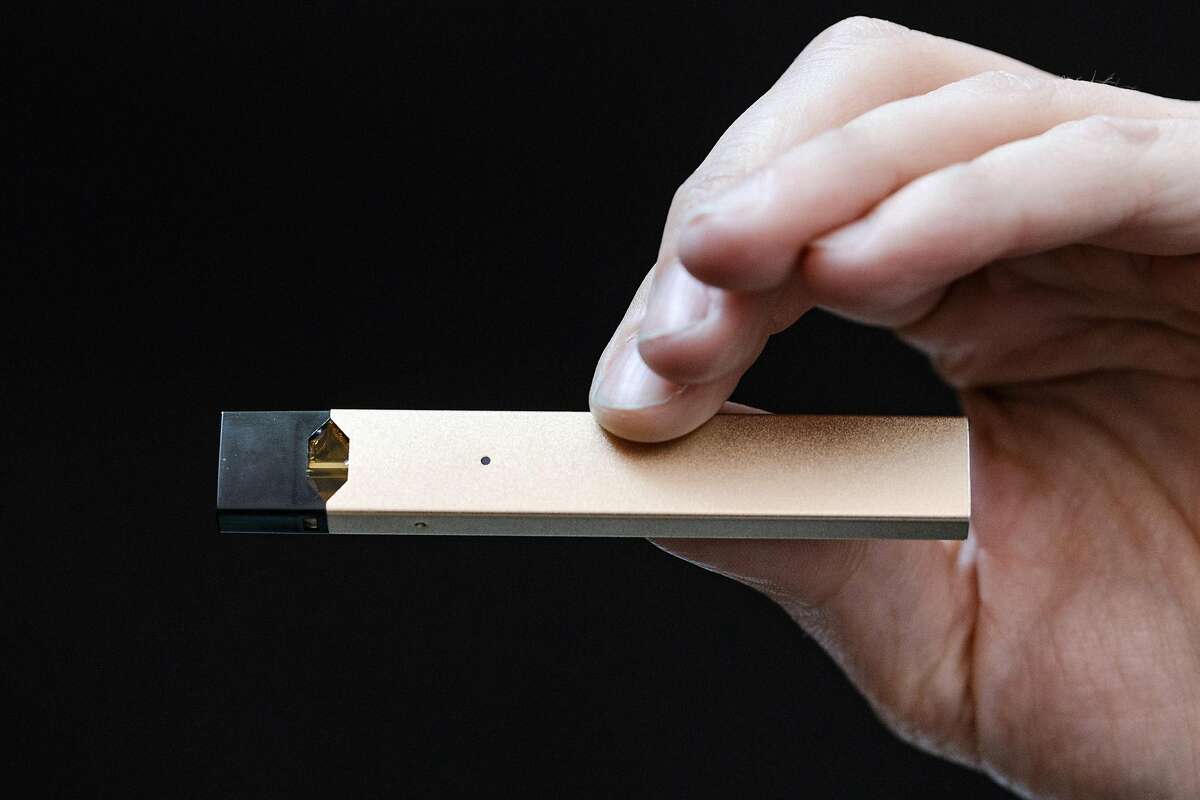 FILE -- Juul Labs co-founder James Monsees holds one of the company’s electronic cigarettes, in San Francisco, May 17, 2018. Of the 10.8 million adults in the United States who are vaping, according to a nationwide survey, 54.6 percent are also smoking cigarettes. (Jason Henry/The New York Times)