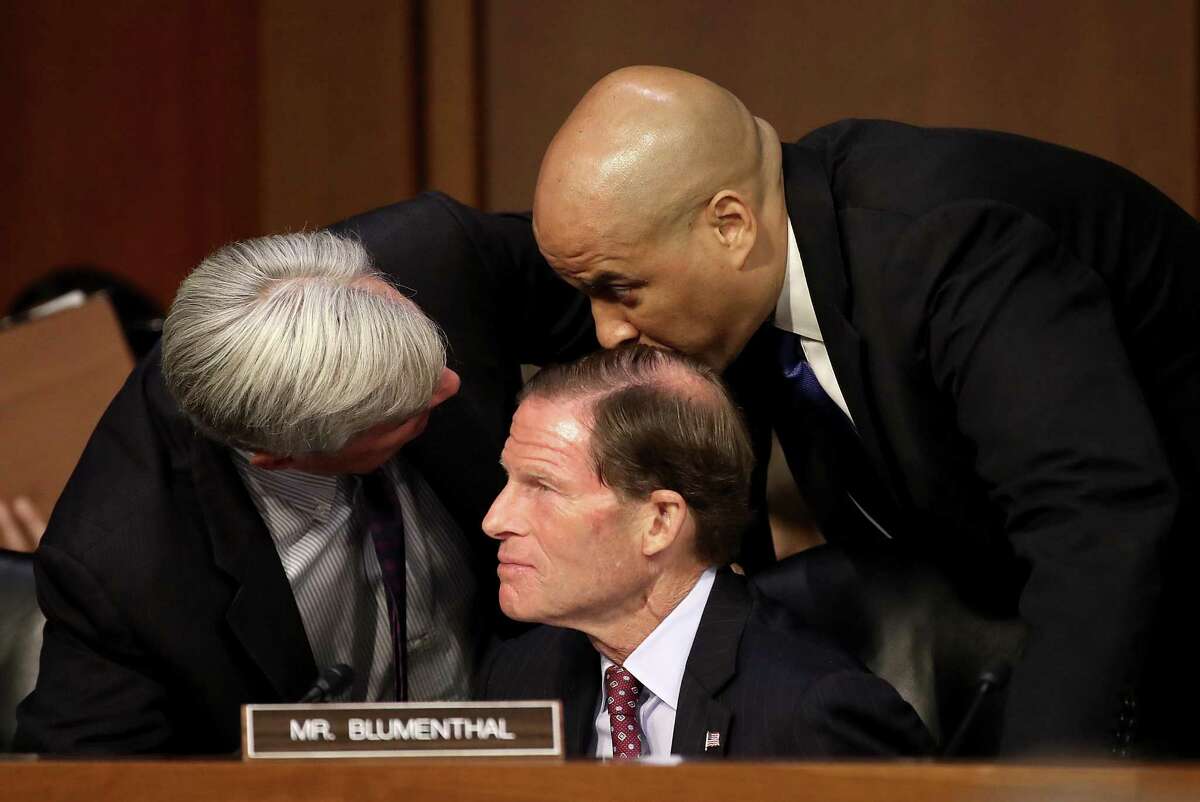 Democratic senators (L-R) Sen. Sheldon Whitehouse (R-RI), Sen. Richard Blumenthal (D-CT) and Sen. Cory Booker (D-NJ) huddle as Supreme Court nominee Judge Brett Kavanaugh's appears for his confirmation hearing before the Senate Judiciary Committee in the Hart Senate Office Building on Capitol Hill September 4, 2018 in Washington, DC. Kavanaugh was nominated by President Donald Trump to fill the vacancy on the court left by retiring Associate Justice Anthony Kennedy.