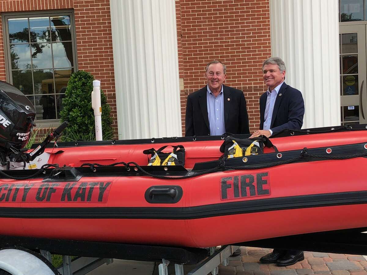 Katy Mayor Chuck Brawner and U.S. Rep. Mike McCaul take a look at a boat that will help the Katy Fire Department respond to high-water rescue calls.