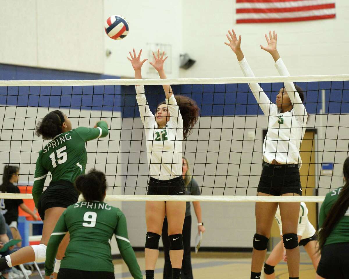Devin Alcoser (22) and Mecca Freeman (5) of Mayde Creek try to block a shot in the first set of a high school volleyball match between the Mayde Creek Rams and the Spring Lions during the 2018 Katy / Cy-Fair Volleyball Classic on August 10, 2018 at Katy Taylor High School, Katy, TX.