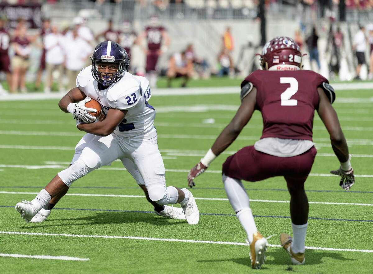 Jaelon Moorehead (22) of the Morton Ranch Mavericks attempts to run up the middle in the first half against the Cinco Ranch Cougars in a high school football game on Saturday, November 4, 2017 at Legacy Stadium in Katy Texas.