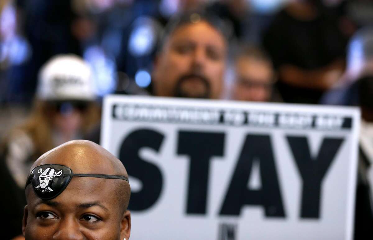 Oakland Raiders fan Autumn Wind Williams (left) listens as Mayor Libby Schaaf details a new football stadium plan at a news conference and rally at the Coliseum in Oakland, Calif. on Saturday, March 25, 2017, in a last ditch effort to convince NFL owners to vote down a proposal to relocate the Raiders to Las Vegas.