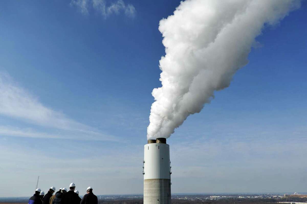 A group visiting Constellation Energy’s coal-fired Brandon Shores Power Plant watches water vapor being released from a scrubber in Anne Arundel County, Md., on Jan. 5, 2012. The Trump administrations rewrite of Obama-era environmental regulations could give new life to coal plants that have not installed advanced pollution controls.