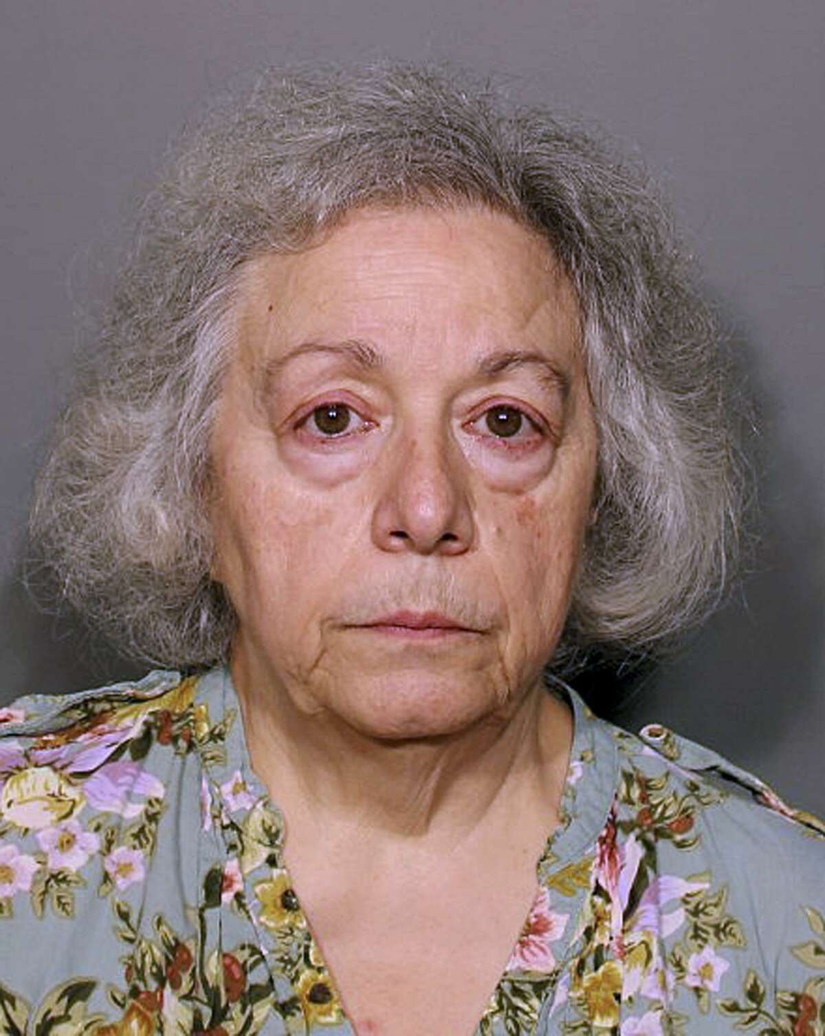 This booking photo released Monday, Aug. 13, 2018, by the New Canaan Police Department shows Marie Wilson, of Wilton, Conn., a former cafeteria worker who along with her sister Joanne Pascarelli was charged with stealing nearly a half-million dollars from New Canaan, Conn., schools over the last five years. (New Canaan Police Department via AP)