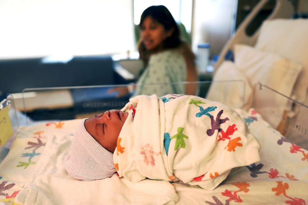 Guadalupe Ramirez, 25, looks at her newborn daughter, Valentina Latrena Marie Crosley, at the University of California San Francisco Mission Bay Women's Hospital in San Francisco, Calif., on Tuesday, September 4, 2018. A new study will be released Wednesday in Health Affairs that aims to explain how California was able to cut down on its maternal death rate even as the rate for the rest of the country rose.