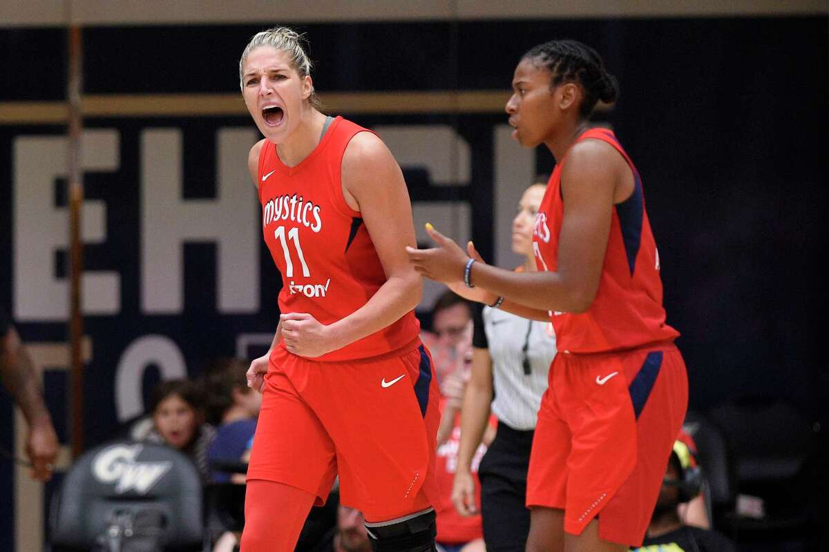 Washington Mystics forward Elena Delle Donne (11) reacts next to Ariel Atkins, right, during the second half of Game 4 of a WNBA basketball playoffs semifinal against the Atlanta Dream, Sunday, Sept. 2, 2018, in Washington. (AP Photo/Nick Wass)
