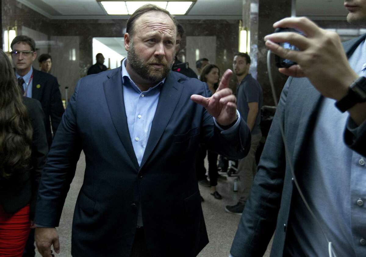 Alex Jones, the right-wing conspiracy theorist, walks the corridors of Capitol Hill after listening to Facebook COO Sheryl Sandberg and Twitter CEO Jack Dorsey testify before the Senate Intelligence Committee on 'Foreign Influence Operations and Their Use of Social Media Platforms' on Capitol Hill, Wednesday, Sept. 5, 2018, in Washington. 