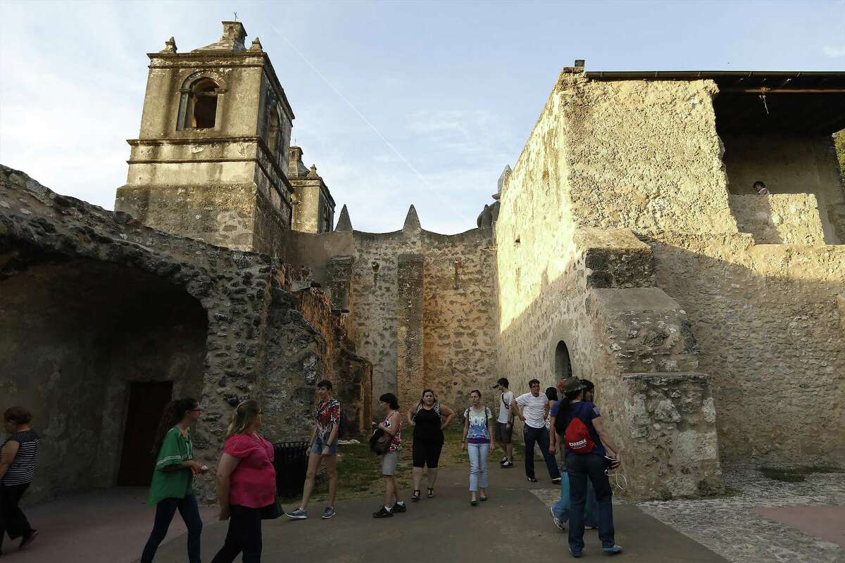 Guests take a walking tour outside Mission Concepcion as part of the World Heritage Site Celebrations on Friday, Oct. 16, 2015. The San Antonio Office of Historic Preservation hosted the event which featured a light projection on the mission of how it originally looked according to officials. Guests were also treated to tours around the mission, music and food. (Kin Man Hui/San Antonio Express-News)