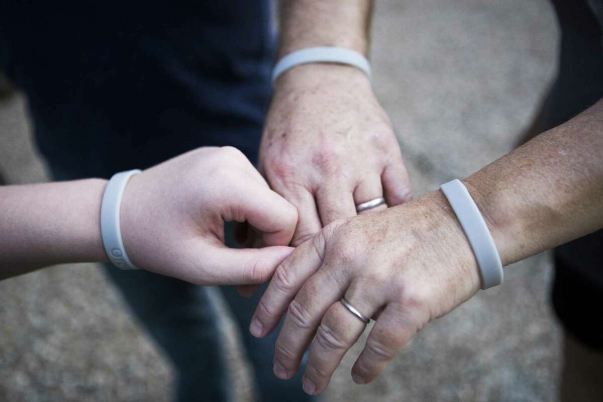 Donnie Blair, 53, and her husband Rodney Blair, 57, and their son Raymond Blair, 11, each use a bracelet that studies positive toxic materials in their home as part of a study by the Baylor College of Medicine. Monday, Aug. 27, 2018. A year after Hurricane Harvey, the family still lives in the second floor of their home while the first floor gets repaired from flood damage.