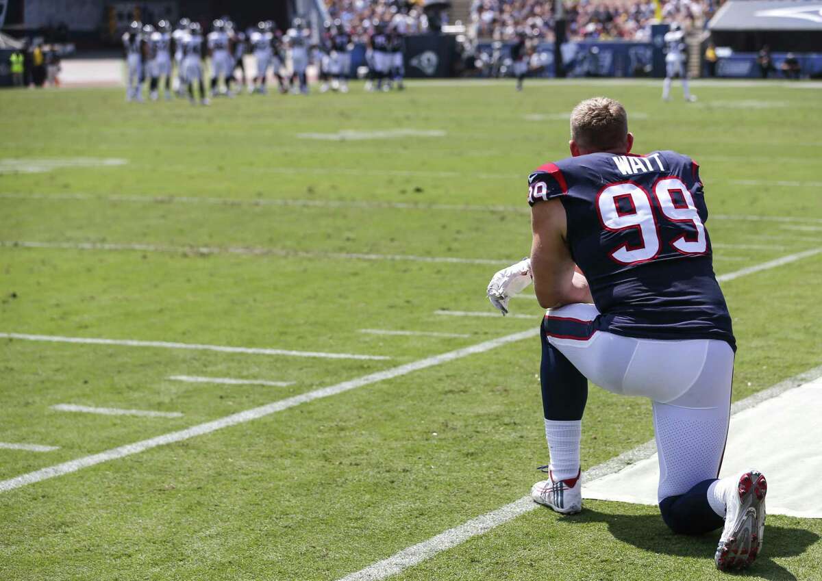 Houston Texans defensive end J.J. Watt (99) kneels on the sidelines watching the first quarter of an NFL preseason football game against the Los Angeles Rams at the Los Angeles Memorial Coliseum on Saturday, Aug. 25, 2018, in Los Angeles.
