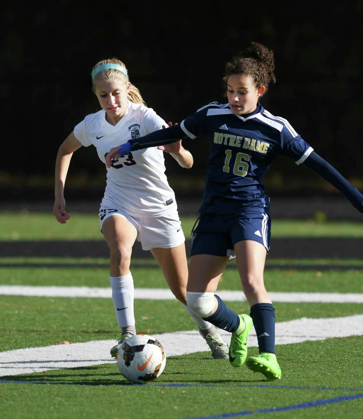 Avery Jarboe, left, of Immaculate, and Toni Domingos, right, compete for possession in the SWC semifinal girls soccer game between Notre Dame and Immaculate at Immaculate High, 10/30/17.