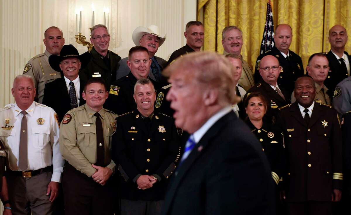 Sheriffs, including Rensselaer County's Patrick Russo, top row, right, listens as President Donald Trump responds to a reporter's question during an event in the East Room of the White House in Washington, Wednesday, Sept. 5, 2018.