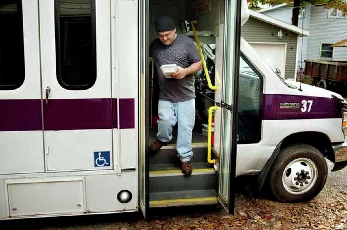 A rider from Sanford exits a County Connection bus outside of his home. (Daily News file photo)