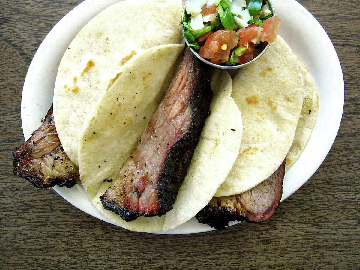 A trio of brisket tacos on handmade flour tortillas with pico de gallo from Garcia's Mexican Food is a popular menu hit.