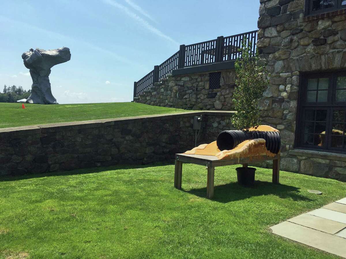 Los Angeles artist Oscar Tuazon created a site specific model, "Model Mother," at The Brant Foundation Art Study Center, where other pieces of his work are on display at the Greenwich, Connecticut, center through October 2018. On Aug. 10, 2018, Urs Fischer's sculpture "Big Clay" rises in the distance.