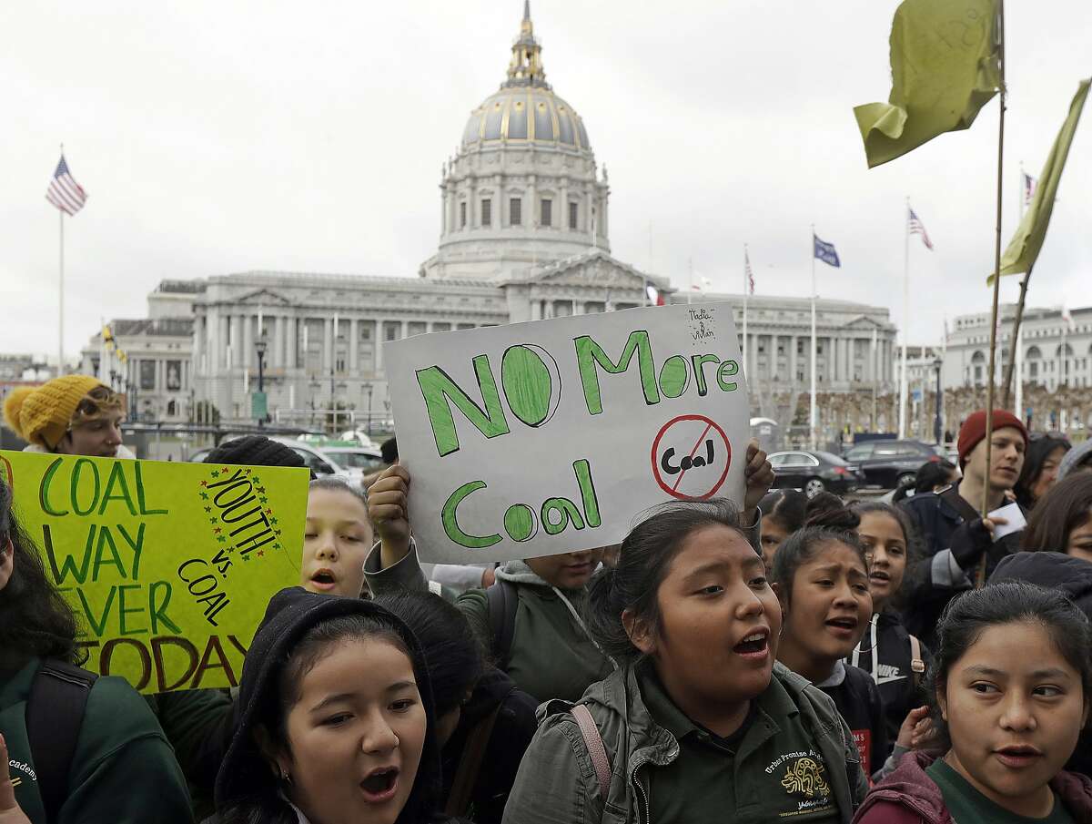 FILE - In this Feb. 28, 2018 file photo, students rally for clean energy in front of San Francisco City Hall. A federal judge presiding over lawsuits accusing big oil companies of lying about global warming is turning his courtroom into a classroom. U.S. District Judge William Alsup has asked lawyers for two California cities and five of the world's largest oil and gas companies to come to court on Wednesday, March 21, 2018 to present "the best science now available on global warming." (AP Photo/Jeff Chiu, File)