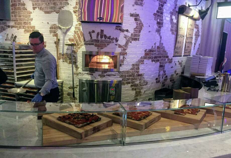 A pizza counter on the walkway outside Cal Mare Italian eatery. Photo: Joe Amarante / Hearst Connecticut Media