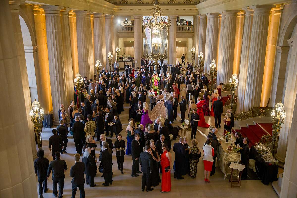 Guests enjoy cocktails and mingling at the War Memorial Opera House during the Opera Ball on Friday, Sept. 8, 2017, in San Francisco, Calif.