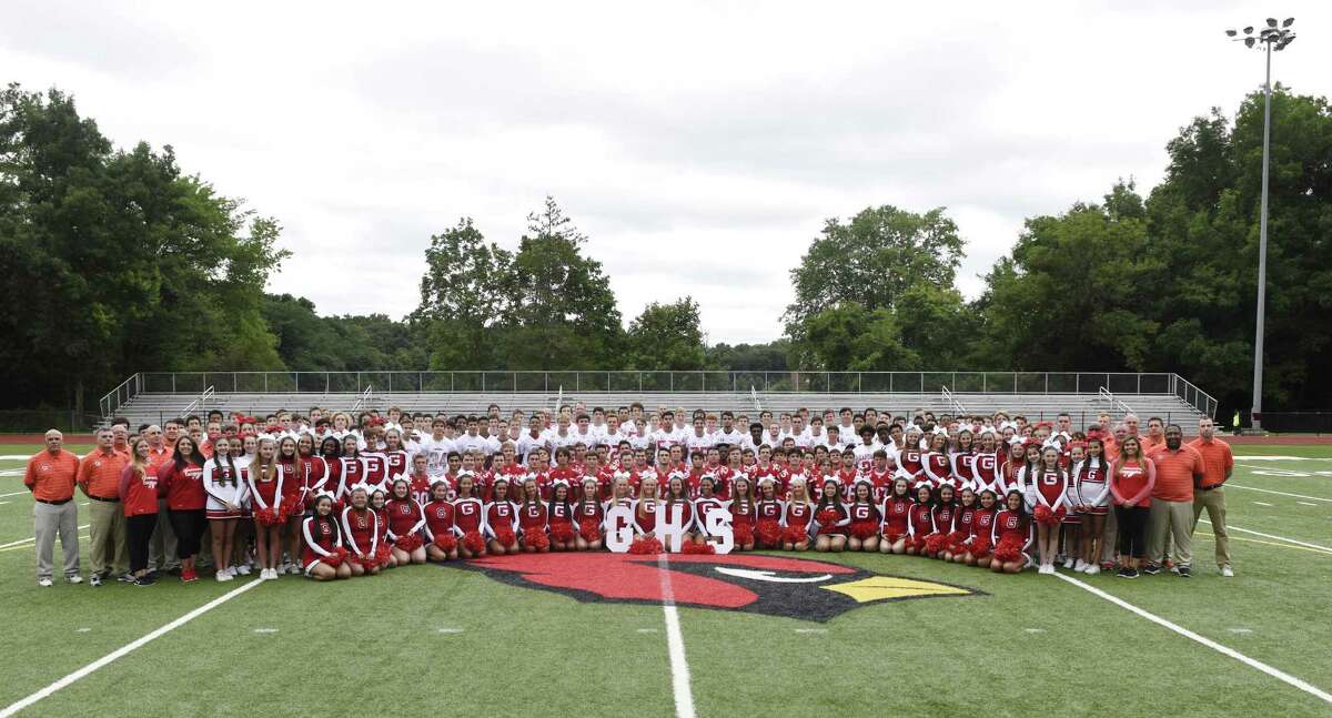 The 2018 Greenwich High School football team, coaches and cheerleaders pose for a team photo on media day at Greenwich High School's Cardinal Stadium in Greenwich, Conn. Sunday, Aug. 19, 2018.