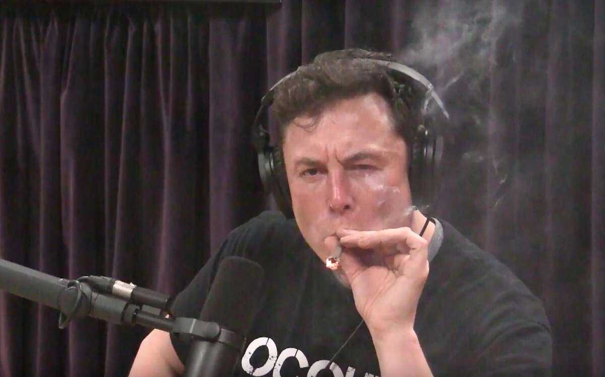 Elon Musk, chairman and CEO at Tesla and chairman of SpaceX, inhales what he said was marijuana on a live YouTube webcast Thursday night. (Screenshot/Youtube)