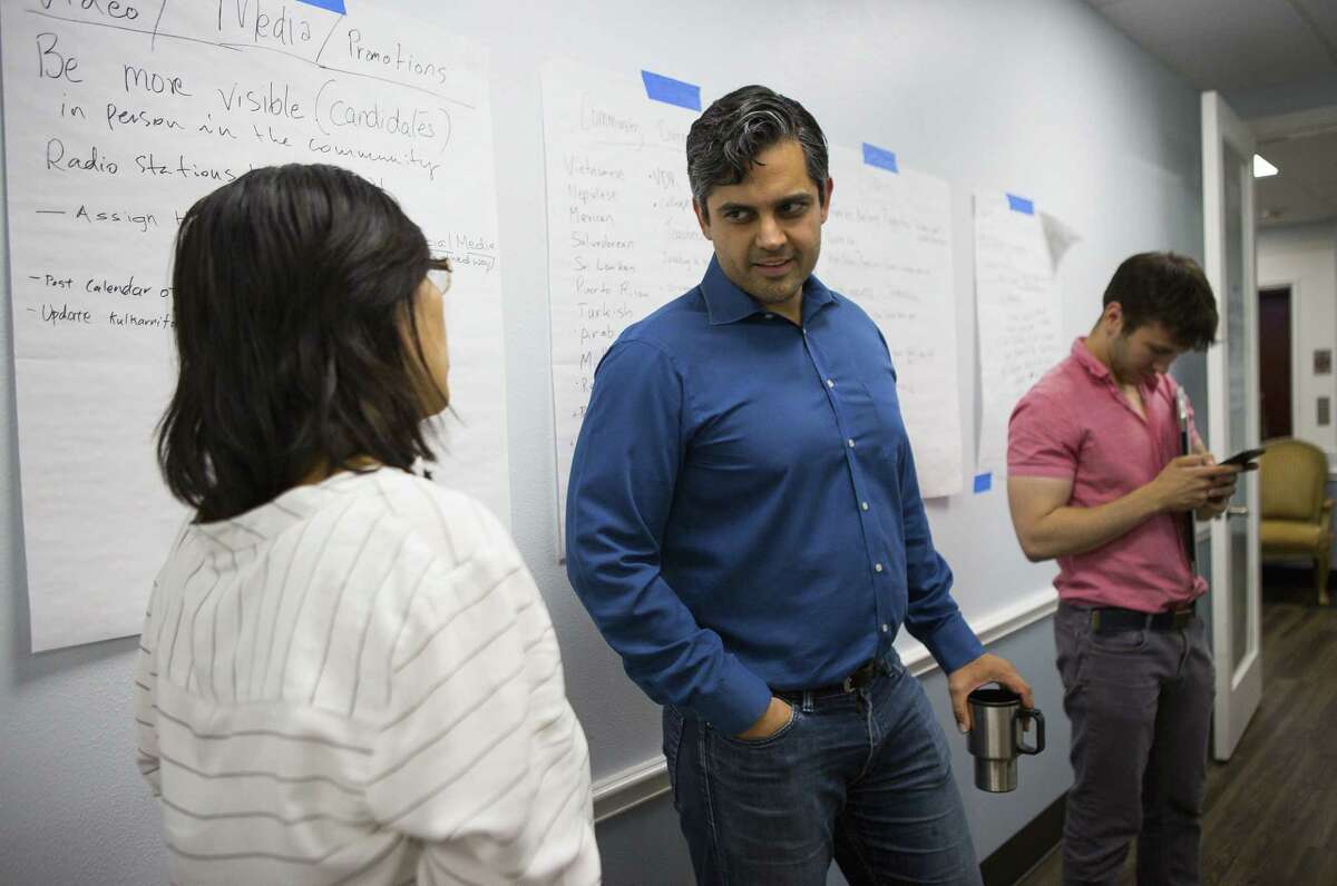 Democrat Sri Preston Kulkarni (center) talks with a supporter in his campaign office on Thursday, Aug. 30, 2018 in Sugar Land. Kulkarni's staff has been running phone banking operations with various volunteers who can speak a diverse group of languages from Mandarin Chinese to Tamil to Spanish. The 22nd Congressional District Kulkarni is running in is considered the most diverse in the state and includes Sugar Land and much of the rest of Fort Bend County.
