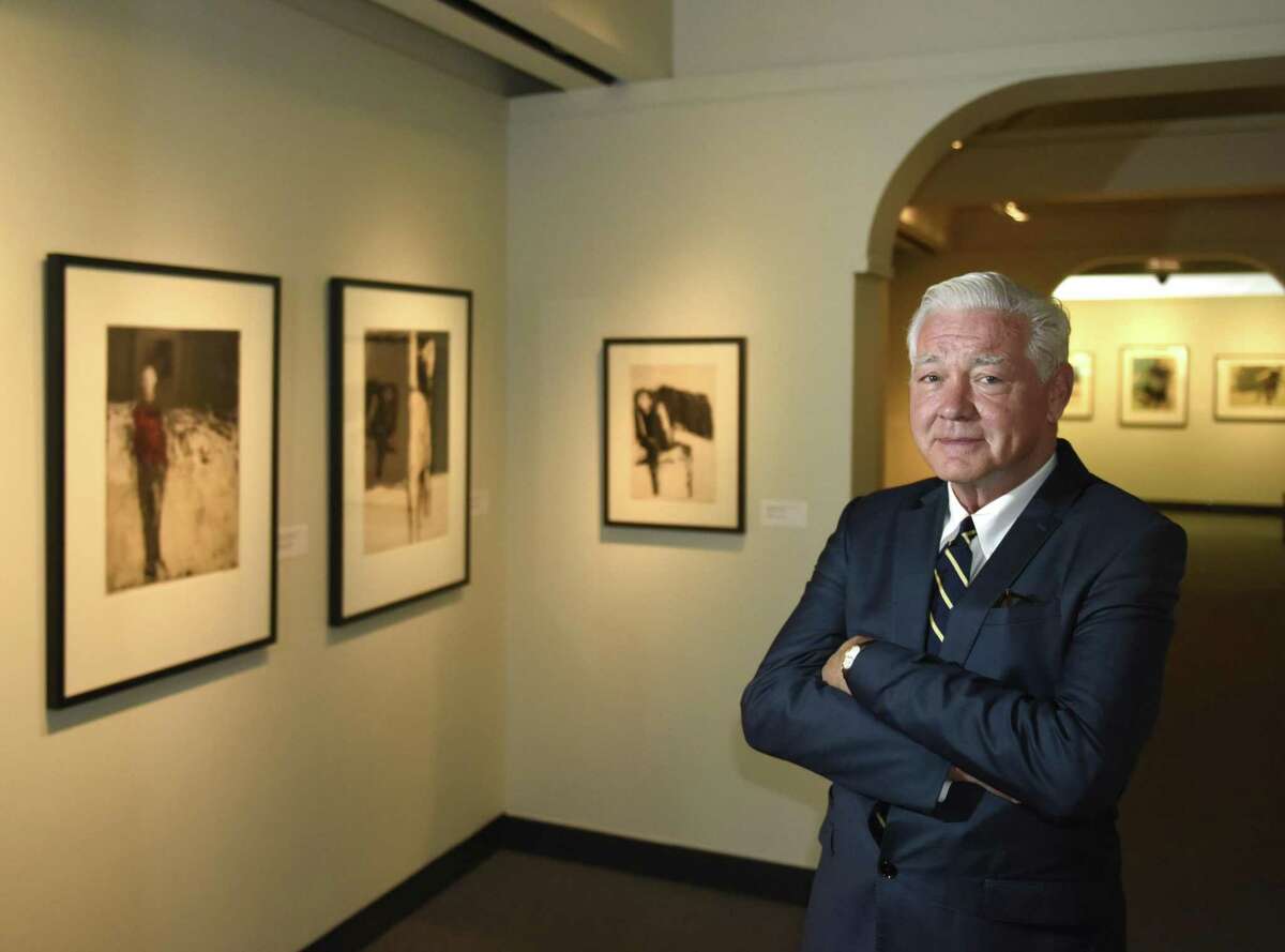 Bruce Museum Executive Director Peter Sutton poses by the "Expressionism in Print: The Early Works of Richard Haas, 1957-64" exhibit at the Bruce Museum in Greenwich, Conn. Thursday, Sept. 6, 2018. Sutton announced his retirement Wednesday after serving 17 years as Executive Director. A scholar of Dutch and Flemish art, Sutton is credited with advancing the museum?’s mission and transforming it from an institution displaying exhibits of local interest into one of the most dynamic mid-size museums in the region with over 78,000 visitors a year.