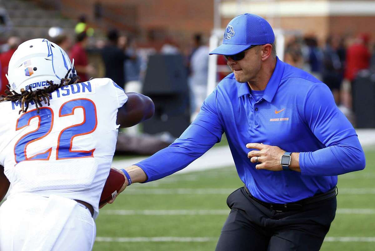 Boise State head coach Bryan Harsin, right, hands of the ball to running back Alexander Mattison as they warm up before a game against Troy on Sept. 1. (AP Photo/Butch Dill)