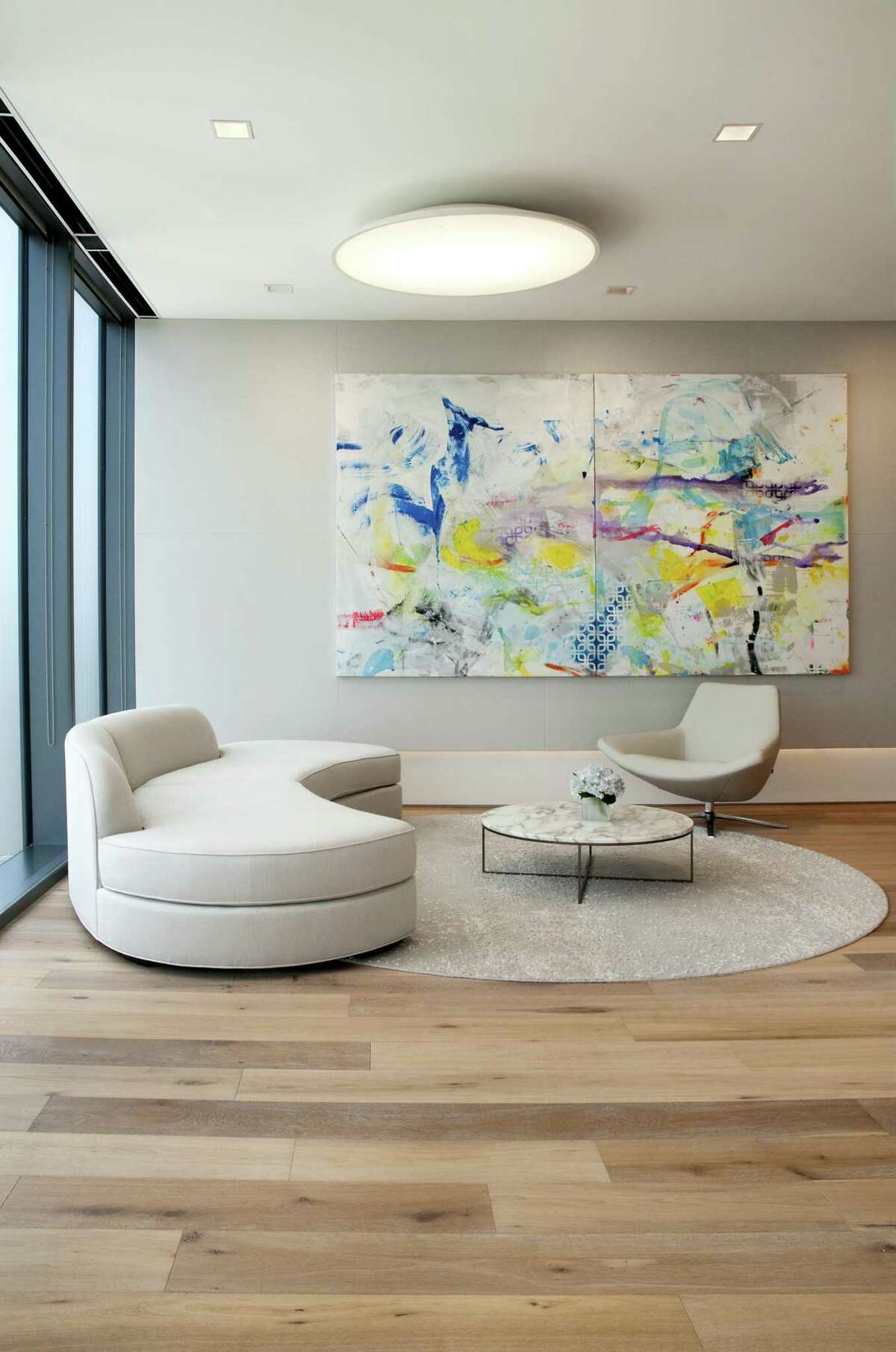 This seating area in the firm’s lounge includes a Martin Durazo painting, "The Answer," courtesy of the Barbara Davis Gallery.