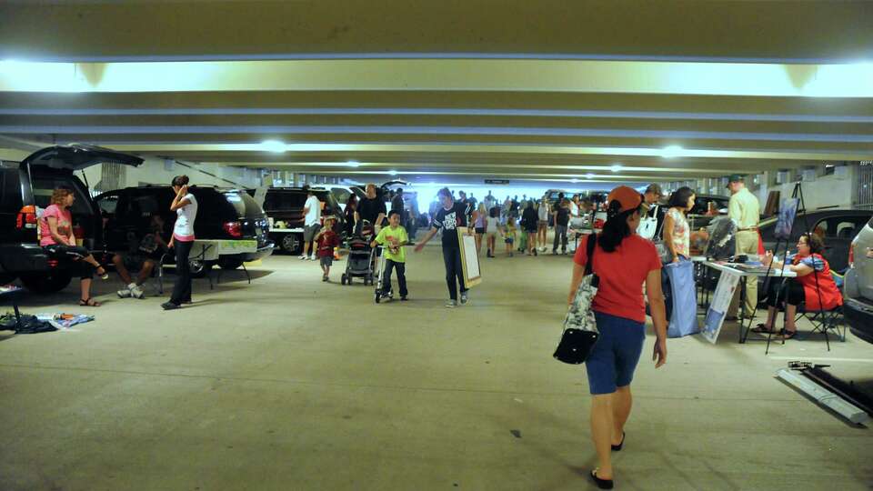 Shoppers hunt for the perfect item during The Woodlands 2017 Fall Flea Market held at the Town Center Parking Garage. The Woodlands residents are able to use the Flea Market to get rid of unused items from their households. The Woodlands covenants don't allow residents to have garage sales in The Woodlands.