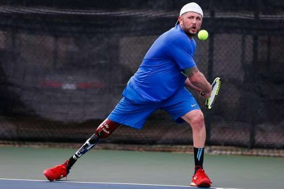 Ambulatory adaptive tennis pro Jeff Bourns sets up for a backhand at Bay Area Racquet Club in Houston. Bourns’ leg was amputated as the result of a congenital birth defect; he was born without his right tibia.