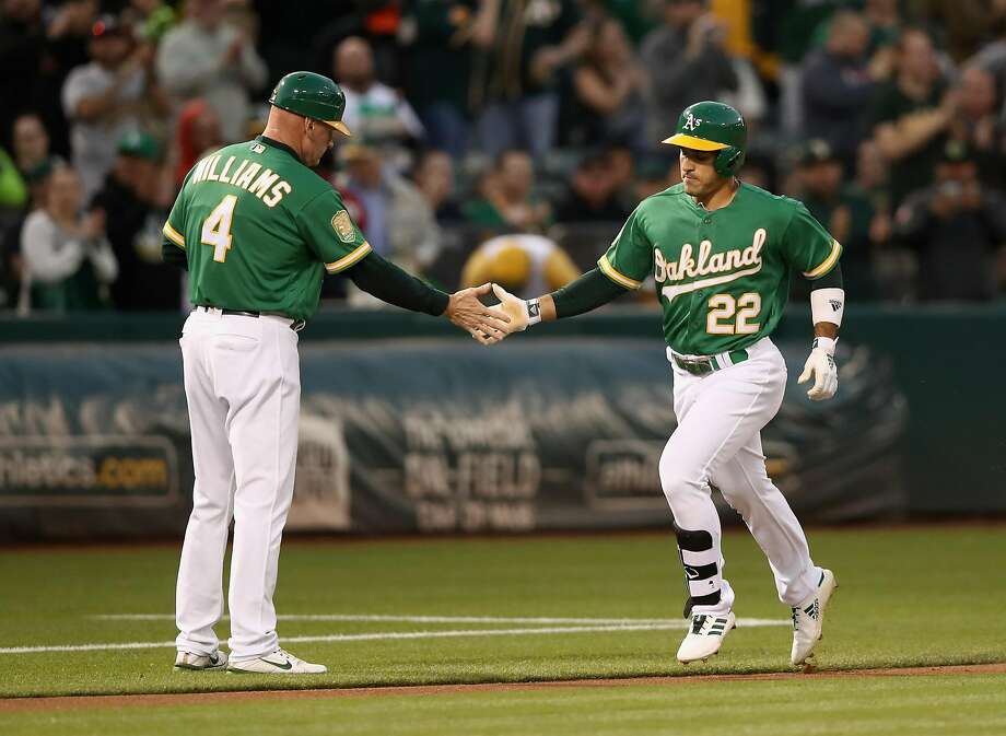 OAKLAND, CA - SEPTEMBER 07: Ramon Laureano # 22 Oakland Athletics is congratulated by third base coach Matt Williams # 4 after making a home run against Yovani Gallardo # 49 of the Texas Rangers at the first run at the Oakland Alameda Coliseum on September 7, 2018 in Oakland, California. (Photo by Ezra Shaw / Getty Images) Photo: Ezra Shaw / Getty Images