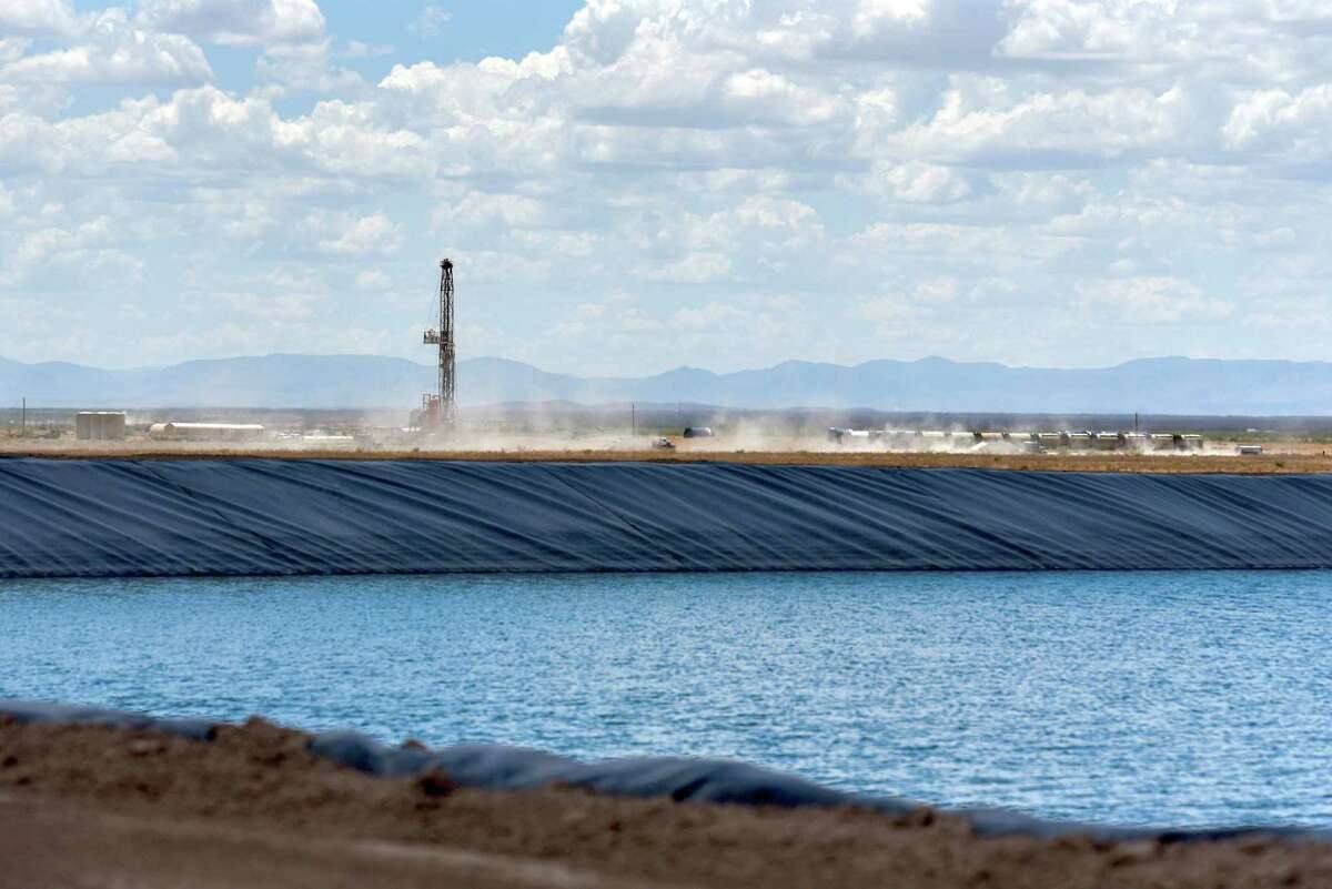 A WaterBridge rig operates behind a Colgate Energy frack pond in Reeves County, Texas, U.S., on Aug. 22, 2018.