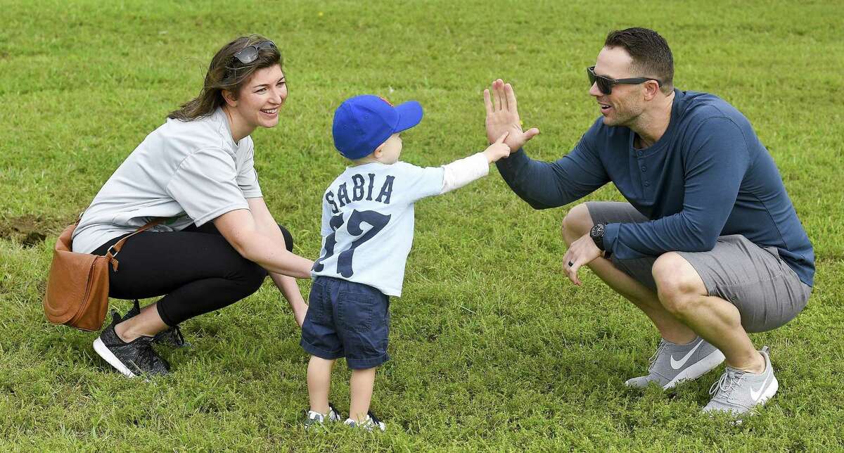 New York Mets third baseman David Wright, at right, shares a high-five with CJ Sabia and Emma, Chris Sabia's wife, as teams compete during the inaugural Christopher Sabia Memorial Wiffle Ball Tournament at Cove Island Park in Stamford on Saturday, Sept. 8, 2018."Sabes" was a Stamford Legion baseball executive, coach and player for over two decades before he passed away from cancer last July at age 39. He was survived by his wife Emma and son CJ.