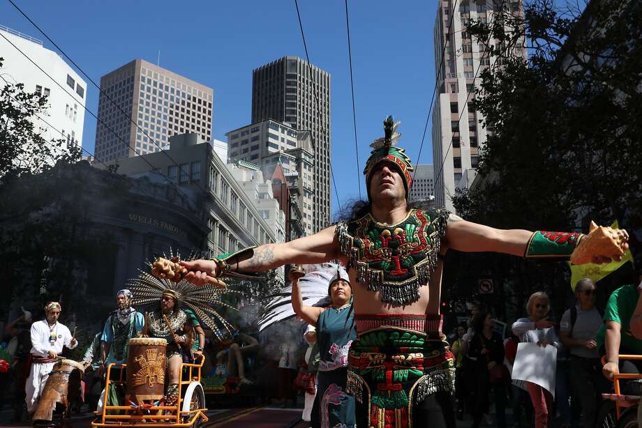 Members of the Danza Azteca Grupo Xiuhcoatl, Mission District, dance on Market Street during the March for Climate, Employment and Justice in San Francisco. Thousands of people demonstrated a few days before the start of the World Summit on Climate Action. Photo: Photos of Yalonda M. James / The Chronicle