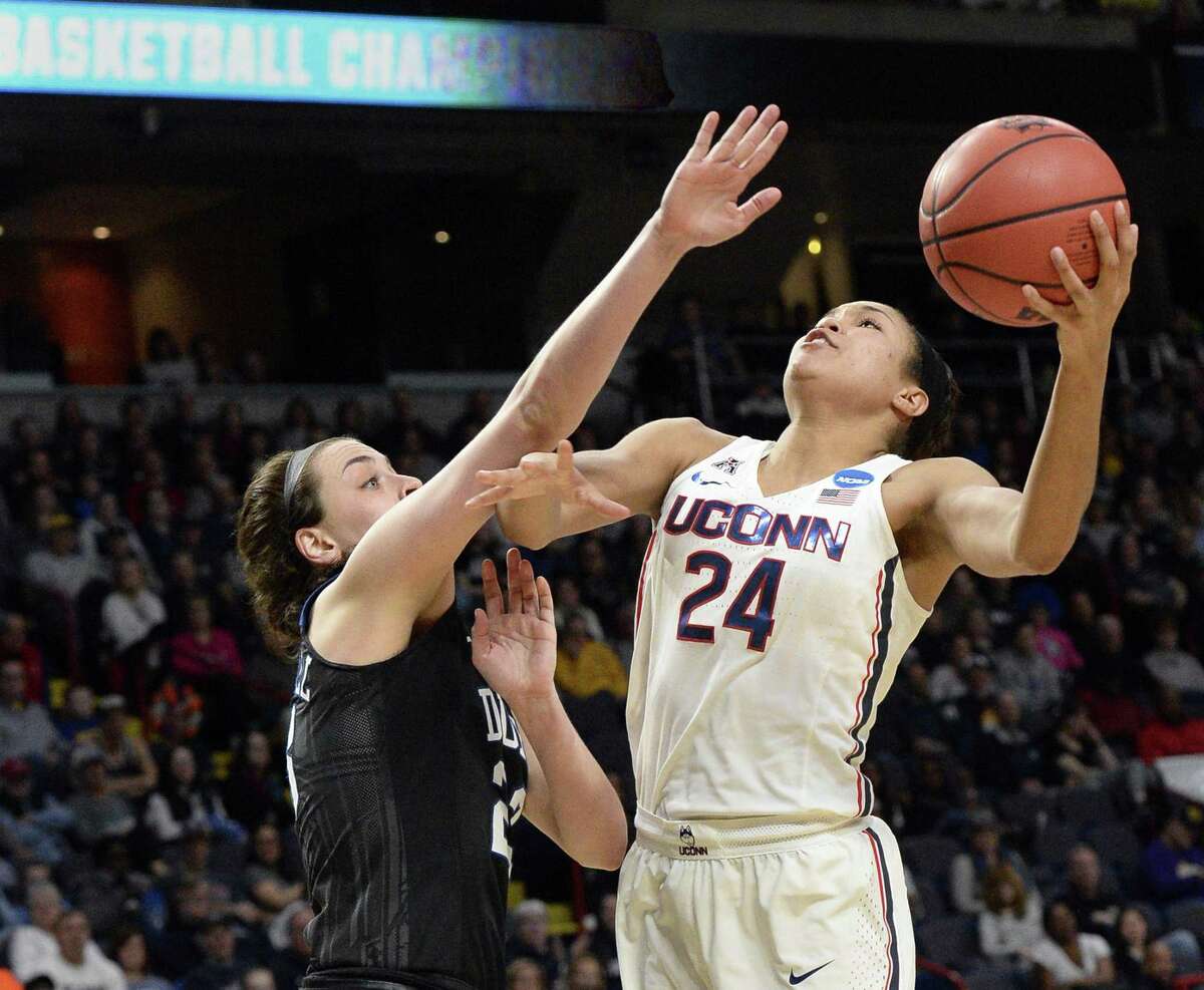 UConn’s Napheesa Collier, right, muscles a shot past Duke’s Rebecca Greenwell during their NCAA Women’s Tournament regional semifinal on March 24 at the Times Union Center in Albany, N.Y.