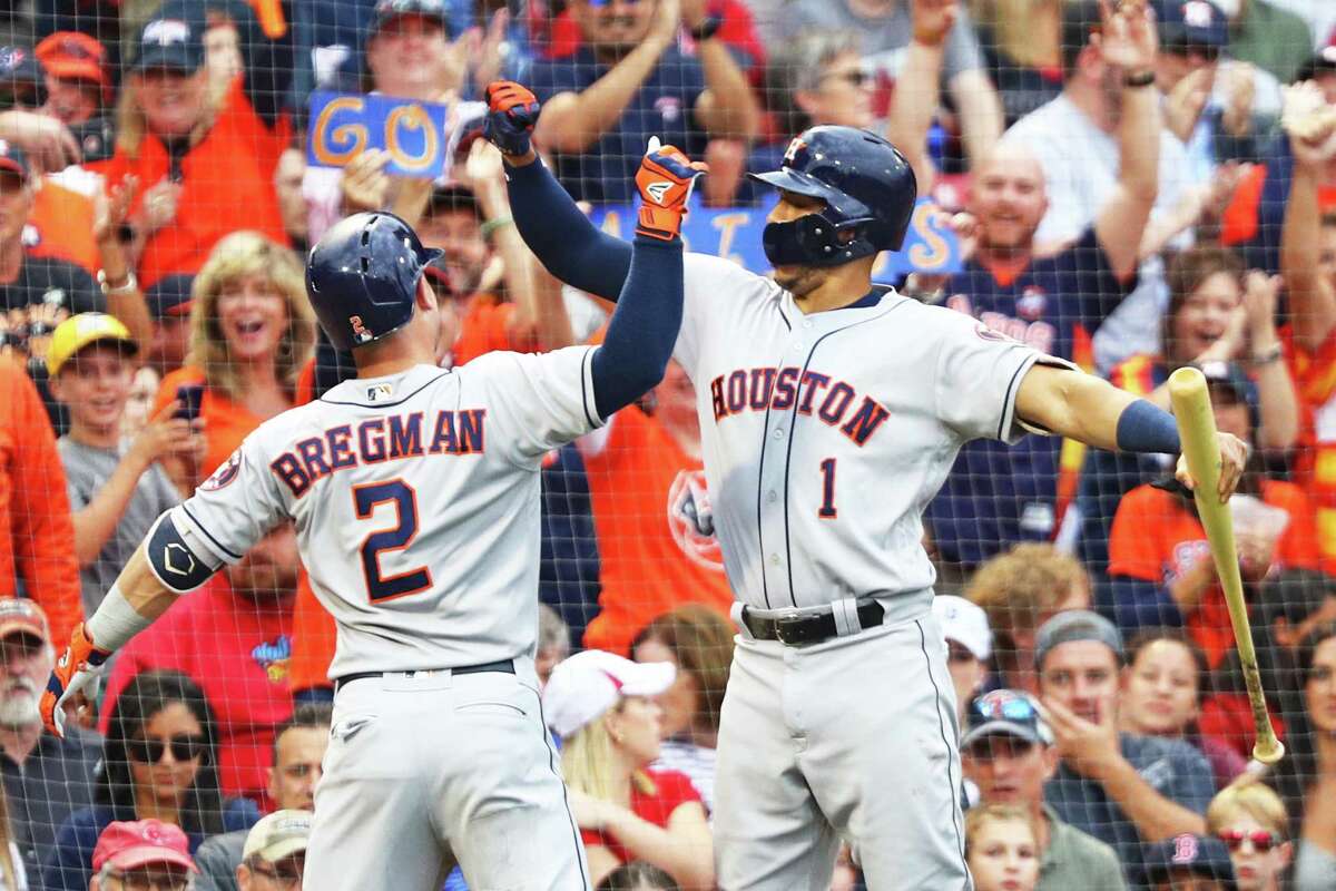 BOSTON, MA - SEPTEMBER 8: Alex Bregman #2 of the Houston Astros celebrates with Carlos Correa #1 after hitting a solo home run against the Boston Red Sox during the third inning at Fenway Park on September 8, 2018 in Boston, Massachusetts.