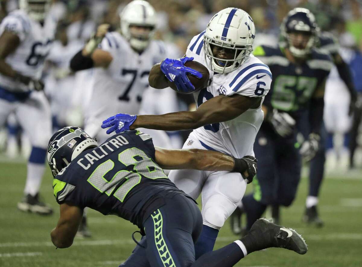 Indianapolis Colts wide receiver Kasen Williams (6) tries to avoid a tackle from Seattle Seahawks linebacker Austin Calitro (58) during the second half of an NFL football preseason game Thursday, Aug. 9, 2018, in Seattle. (AP Photo/Elaine Thompson)
