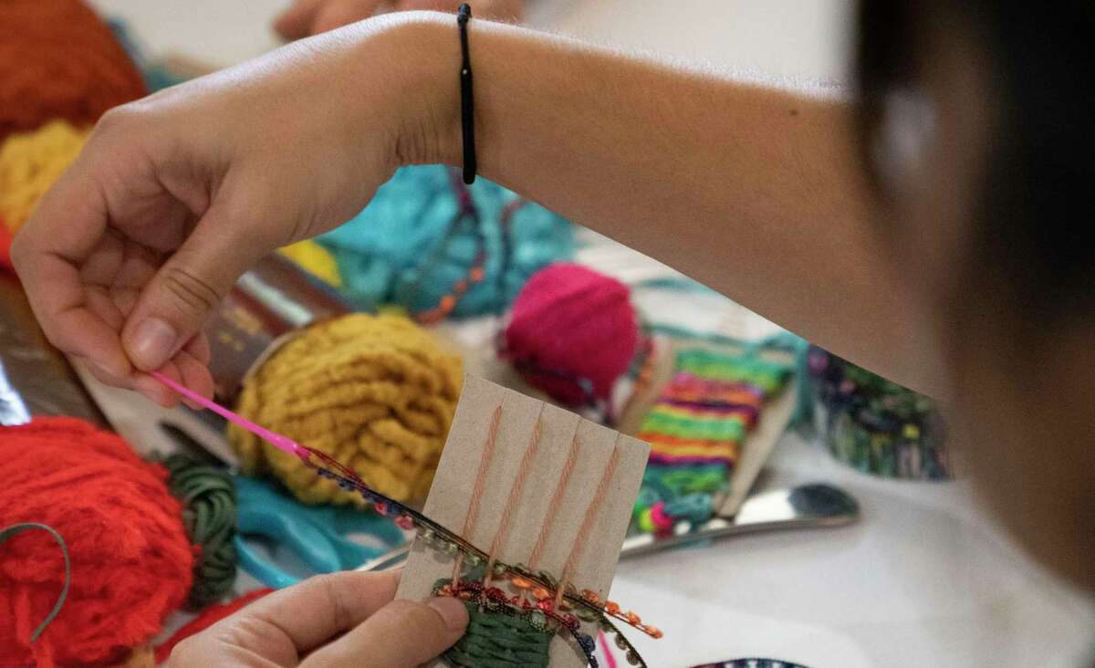 Visitors enjoy learning about hand weaving at San Antonio’s Mission Espada
