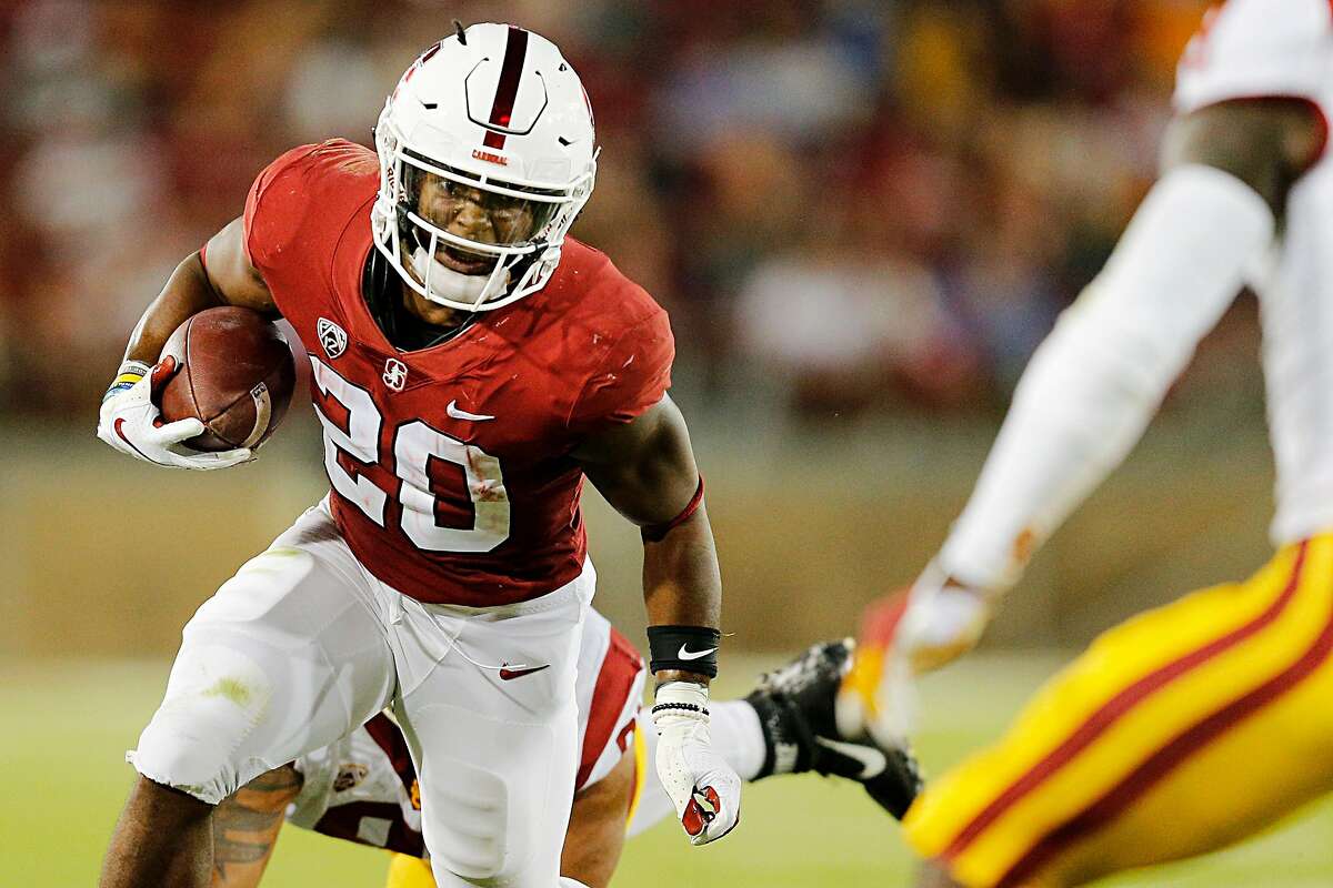 Stanford Cardinal running back Bryce Love (20) fights for more yards in a run play during the third quarter of an NCAA football game between Stanford Cardinal and USC Trojans at Stanford Stadium, Saturday, Sept. 8, 2018, in Stanford, Calif.