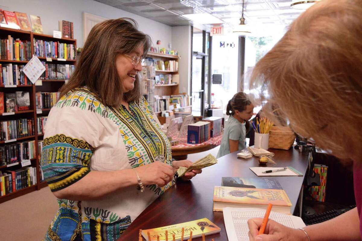 Kate Schuman from North Saem purchases the new Harry Potter book at Byrd's Books in Bethel on Sunday, July 31, 2016.