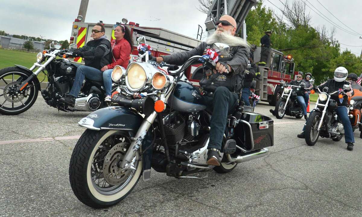 Seymour's Wayne Gwazda rides under the flag at the finish in Seaside Park of the 18th Annual CT United Ride on Sunday September 9, 2018 in Bridgeport Conn. Almost 2,000 motorcycle riders took part in Connecticut's largest annual 9/11 tribute riding from Norwalk through Fairfield County to Bridgeport's Seaside Park