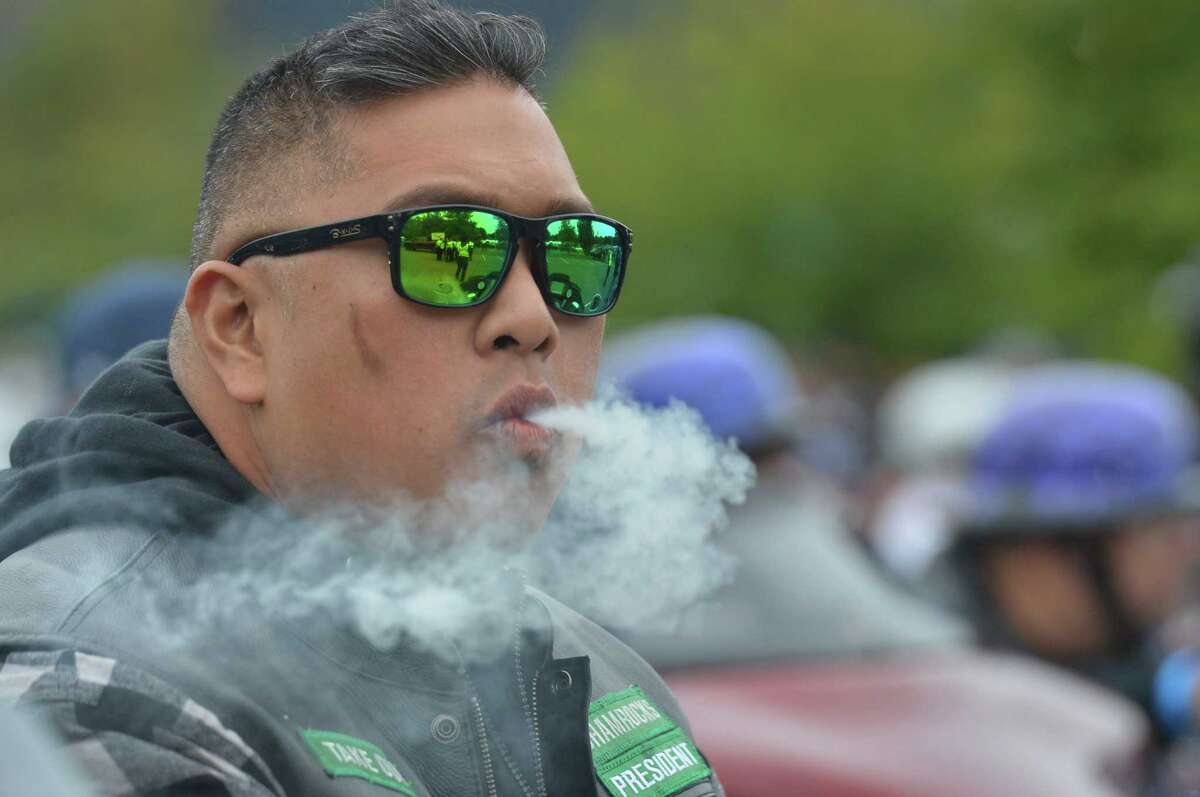 Roman Ilustre enjoys a cigar before the start the 18th Annual CT United Ride at Norden Park on Sunday September 9, 2018 in Norwalk Conn. Almost 2,000 motorcycle riders took part in Connecticut's largest annual 9/11 tribute riding from Norwalk through Fairfield County to Bridgeport's Seaside Park