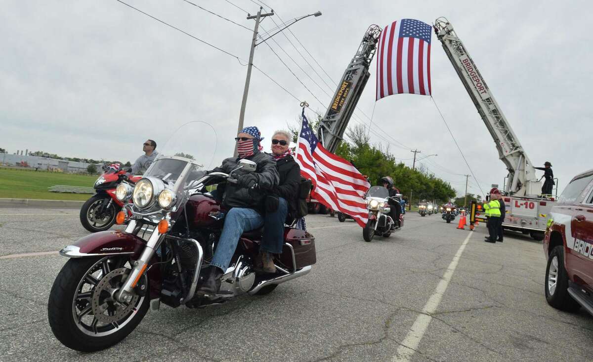 Riders pass under the American flag at the finish in Seaside Park of the 18th Annual CT United Ride on Sunday September 9, 2018 in Bridgeport Conn. Almost 2,000 motorcycle riders took part in Connecticut's largest annual 9/11 tribute riding from Norwalk through Fairfield County to Bridgeport's Seaside Park