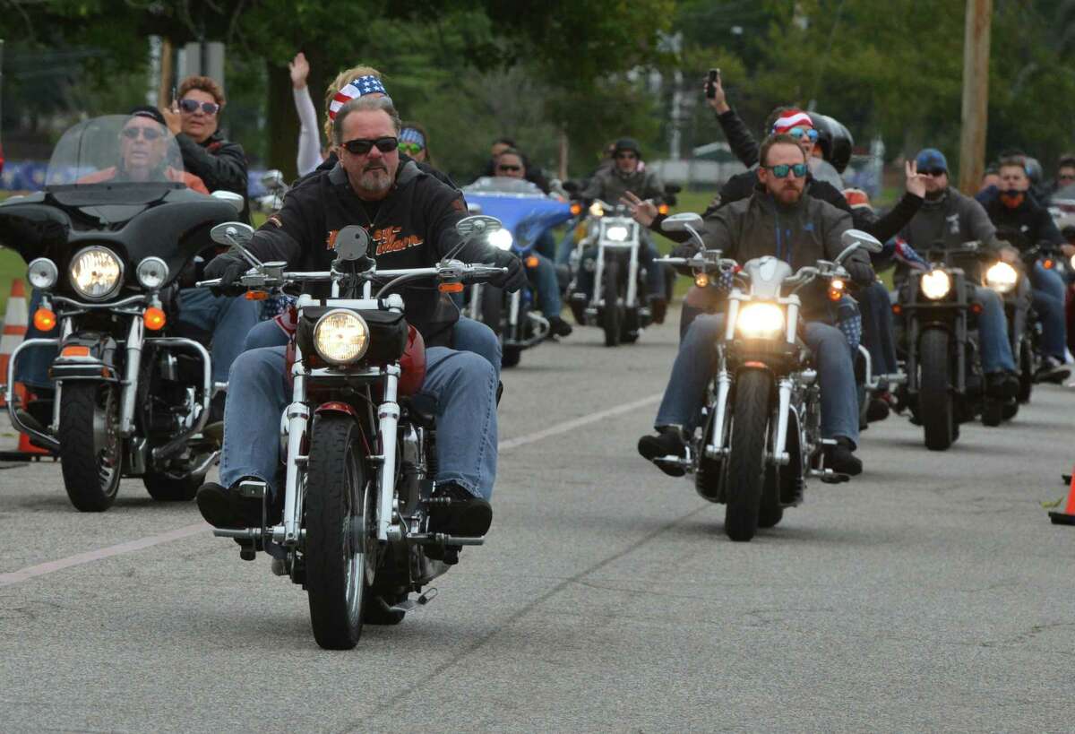 Riders pass under the American flag at the finish in Seaside Park of the 18th Annual CT United Ride on Sunday September 9, 2018 in Bridgeport Conn. Almost 2,000 motorcycle riders took part in Connecticut's largest annual 9/11 tribute riding from Norwalk through Fairfield County to Bridgeport's Seaside Park