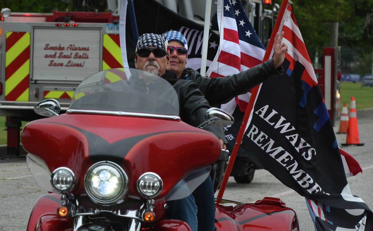 Riders pass under the American flag at the finish in Seaside Park of the 18th Annual CT United Ride on Sunday September 9, 2018 in Bridgeport Conn. Almost 2,000 motorcycle riders took part in Connecticut's largest annual 9/11 tribute riding from Norwalk through Fairfield County to Bridgeport's Seaside Park
