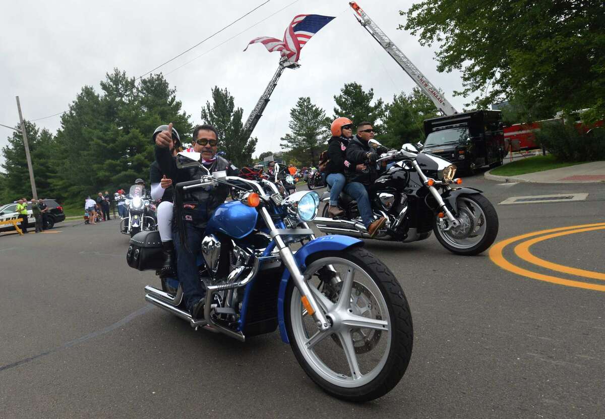 Riders pass under the American flag at the start the 18th Annual CT United Ride at Norden Park on Sunday September 9, 2018 in Norwalk Conn. Almost 2,000 motorcycle riders took part in Connecticut's largest annual 9/11 tribute riding from Norwalk through Fairfield County to Bridgeport's Seaside Park