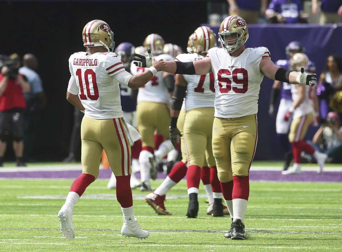 San Francisco 49ers quarterback Jimmy Garoppolo (10) celebrates with teammate Mike McGlinchey (69) after throwing a 22-yard touchdown pass to Dante Pettis during the second half of an NFL football game against the Minnesota Vikings, Sunday, Sept. 9, 2018, in Minneapolis. (AP Photo/Jim Mone)